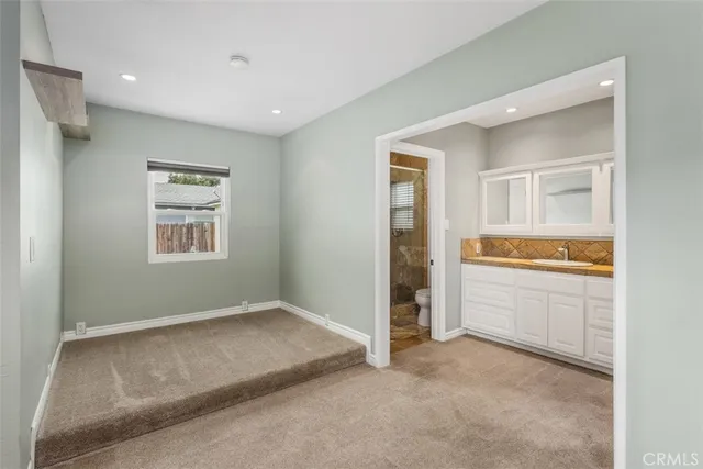 a view of an empty room with a kitchen