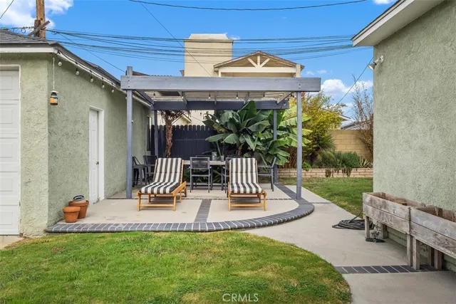 a view of a patio with a table and chairs