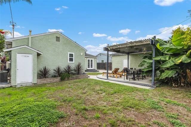 a front view of a house with patio and garden