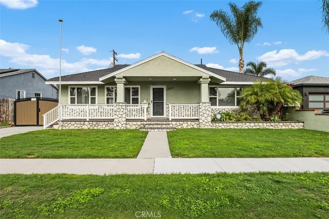 a front view of a house with a garden and plants