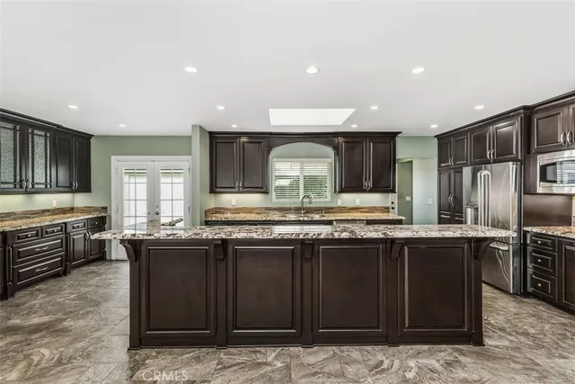 a kitchen with stainless steel appliances granite countertop a stove and a sink