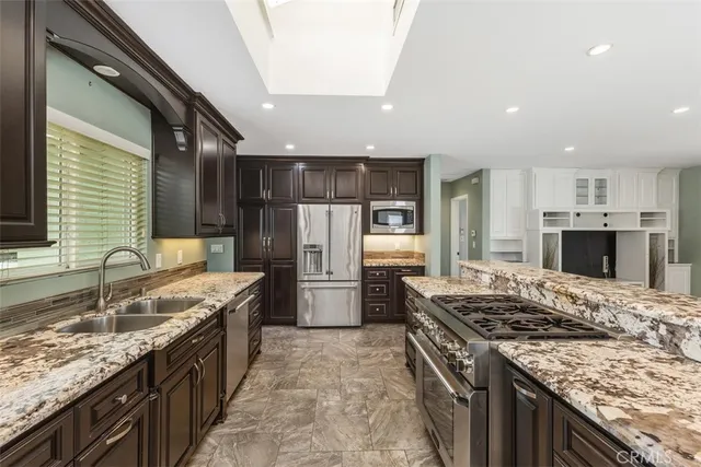 a kitchen with a stove sink and refrigerator
