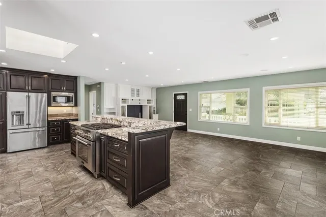 a kitchen with stainless steel appliances granite countertop a stove and a refrigerator