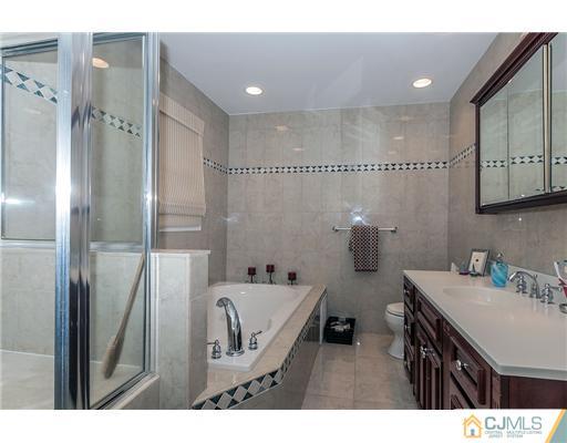 23 Tamarack Road Edison, NJ 08820 - Photo 14 of 23 a bathroom with a sink and a mirror
