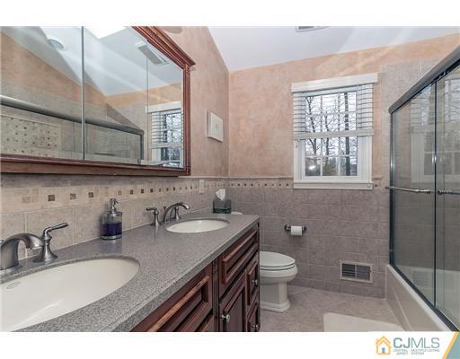 23 Tamarack Road Edison, NJ 08820 - Photo 15 of 23 a bathroom with a sink a toilet and a mirror