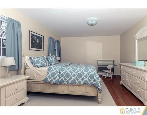 23 Tamarack Road Edison, NJ 08820 - Photo 16 of 23 a bedroom with a bed and a couch