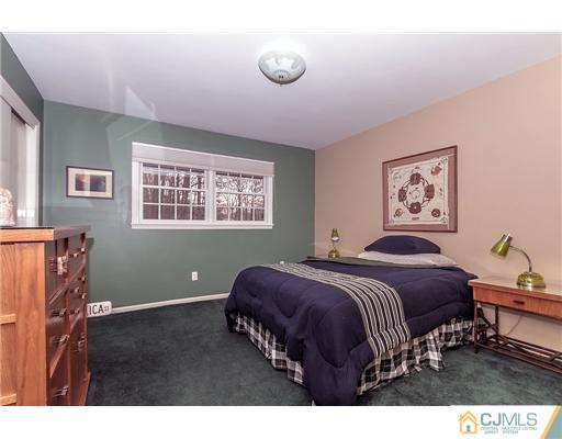 23 Tamarack Road Edison, NJ 08820 - Photo 17 of 23 a bedroom with a bed and a window