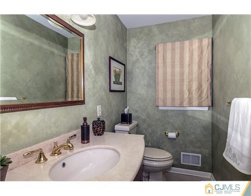 23 Tamarack Road Edison, NJ 08820 - Photo 9 of 23 a bathroom with a sink a toilet and mirror
