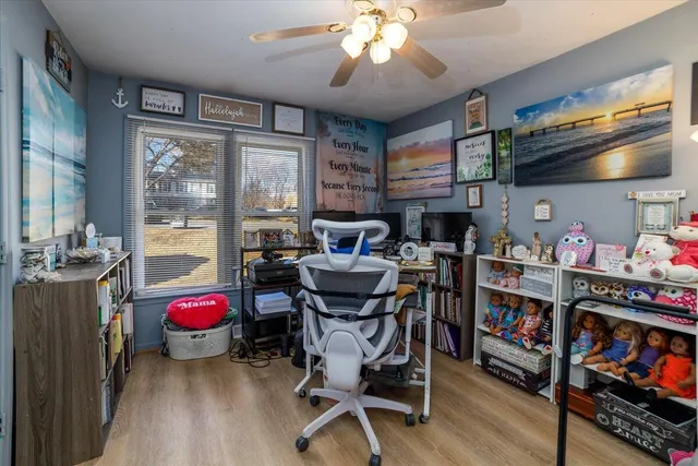 a view of a dining room with furniture a chandelier and wooden floor
