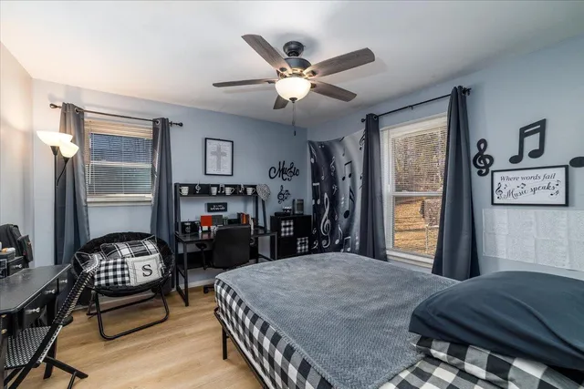 a bed room with furniture and window