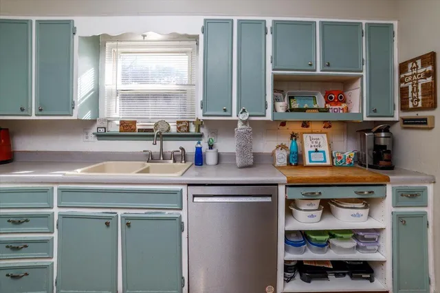 a kitchen with stainless steel appliances granite countertop a sink and a window