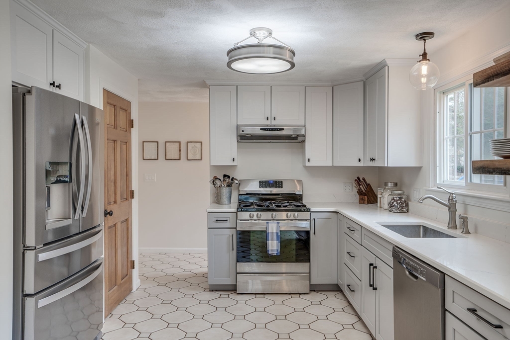71 Houghton's Mill Road Lunenburg, MA 01462 - Photo 11 of 39 a kitchen with stainless steel appliances granite countertop a refrigerator sink and stove