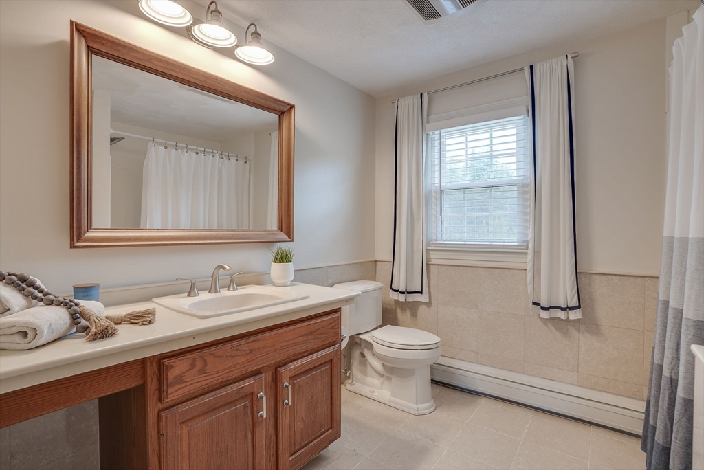 71 Houghton's Mill Road Lunenburg, MA 01462 - Photo 20 of 39 a bathroom with a toilet sink and mirror
