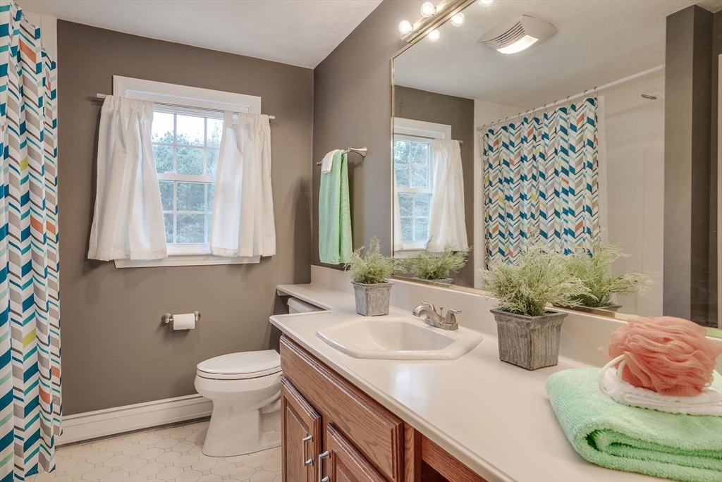 71 Houghton's Mill Road Lunenburg, MA 01462 - Photo 24 of 39 a bathroom with a sink a toilet and mirror