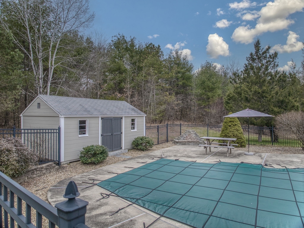 71 Houghton's Mill Road Lunenburg, MA 01462 - Photo 33 of 39 a backyard of a house with table and chairs under an umbrella