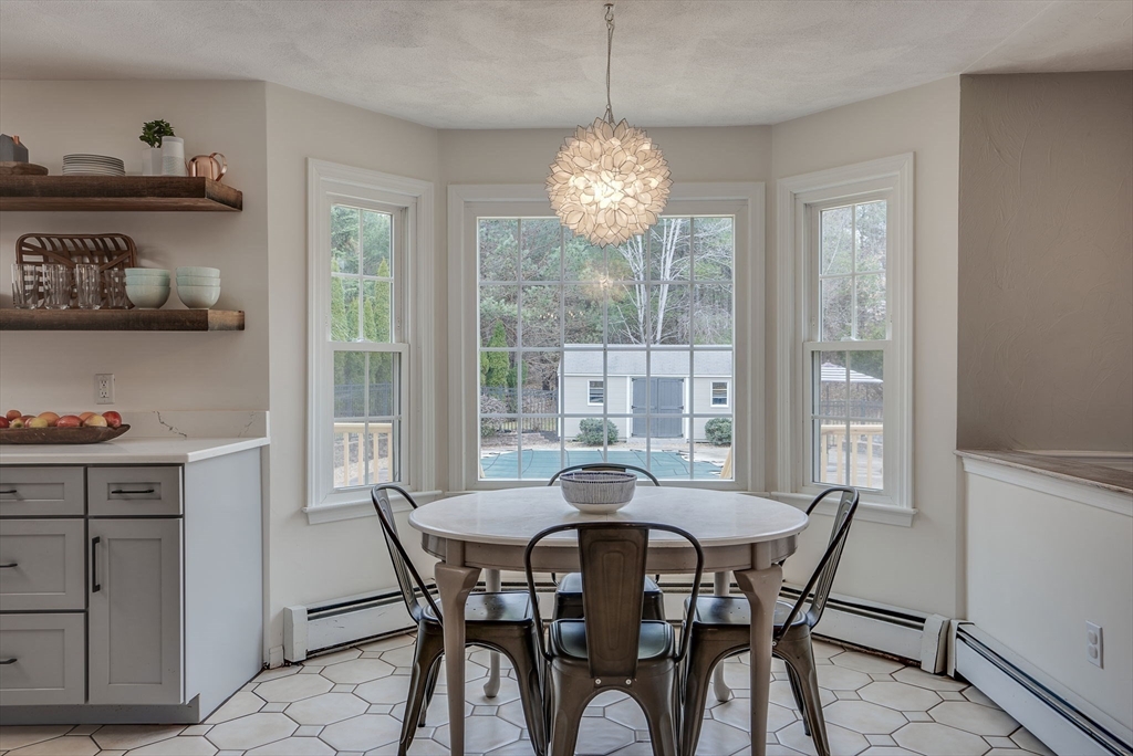 71 Houghton's Mill Road Lunenburg, MA 01462 - Photo 10 of 39 a view of a dining room with furniture large windows and wooden floor