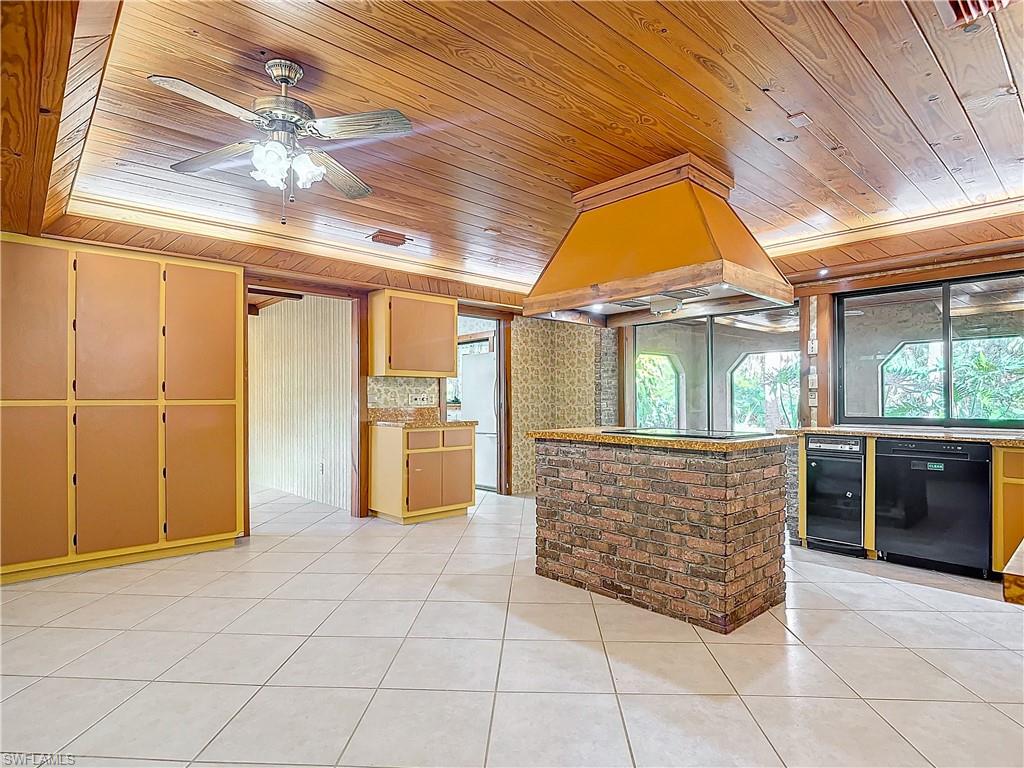 3550 11th Avenue Southwest Naples, FL 34117 - Photo 11 of 35 Kitchen with black appliances, wooden ceiling, and custom exhaust hood