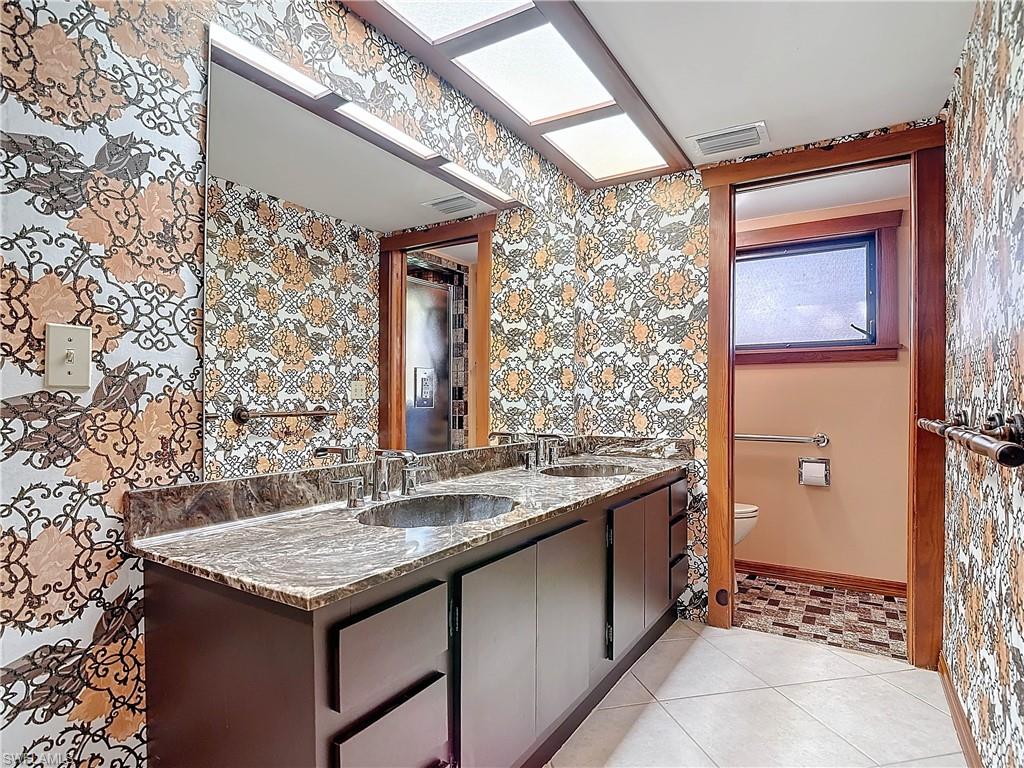 3550 11th Avenue Southwest Naples, FL 34117 - Photo 28 of 35 Master Bathroom featuring tile patterned floors, vanity, and toilet