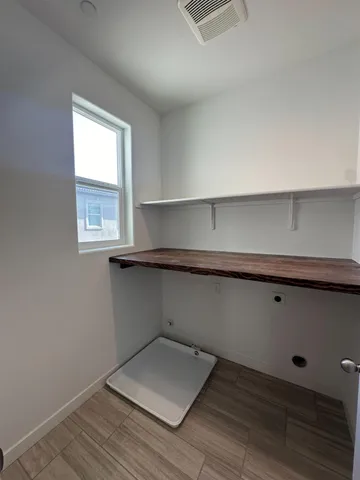 an empty room with wooden floor and window