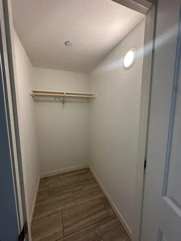 a view of a room with wooden floor