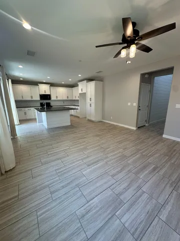 a view of kitchen and living room with wooden floor