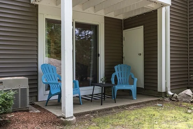 a view of a house with a yard and sitting area
