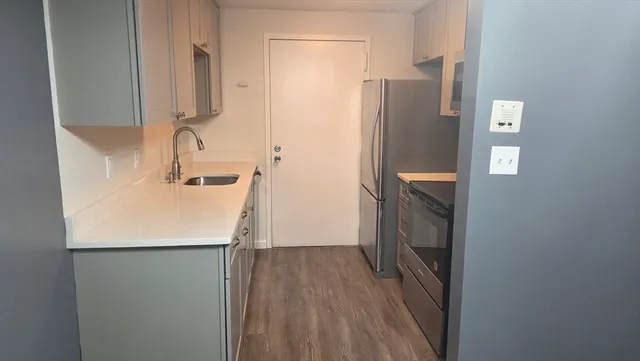 a kitchen with a sink and a refrigerator