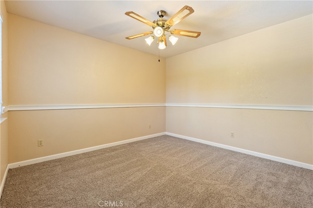 6815 Santa Lucia Road, Unit 5 Atascadero, CA 93422 - Photo 31 of 44 Bedroom 3 also features a decorative chair rail and a ceiling fan.