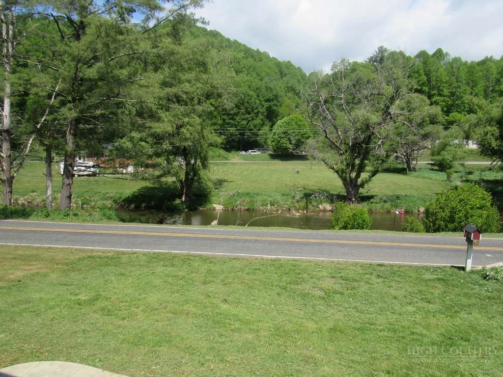 805 Ed Little Road Warrensville, NC 28693 - Photo 12 of 49 a view of a yard with a trampoline