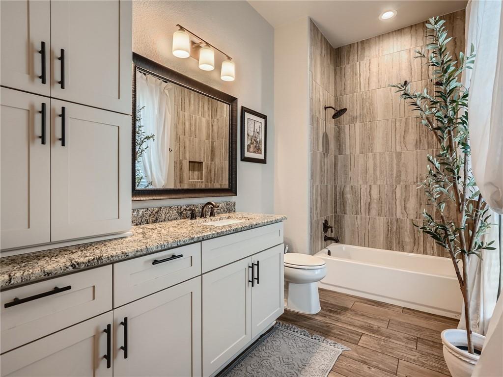 132 Huerta Road Florence, TX 76527 - Photo 25 of 40 Granite counters and wood-look tile flooring elevate this functional and refreshed bathroom.