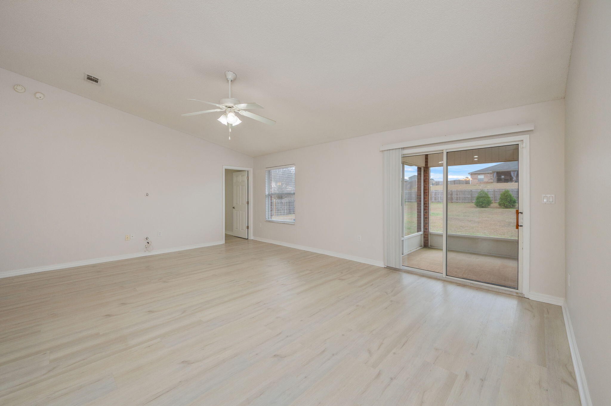 2405 Cumberland Way Crestview, FL 32536 - Photo 12 of 47 wooden floor in an empty room with a window