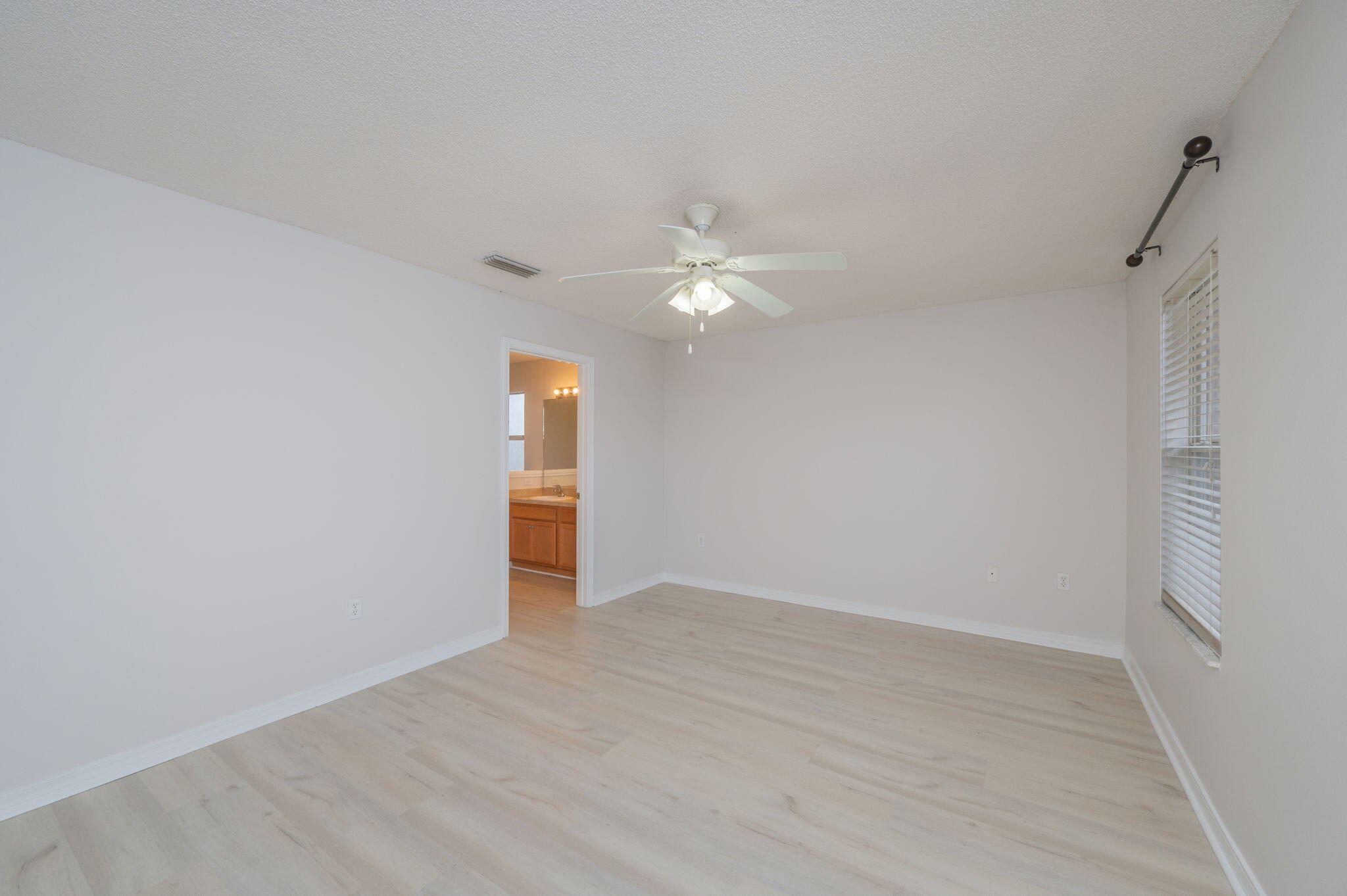 2405 Cumberland Way Crestview, FL 32536 - Photo 20 of 47 a view of an empty room with a ceiling fan