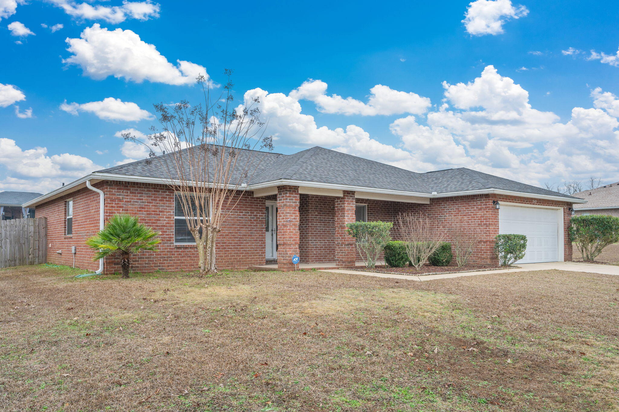 2405 Cumberland Way Crestview, FL 32536 - Photo 2 of 47 a front view of a house with a yard and garage