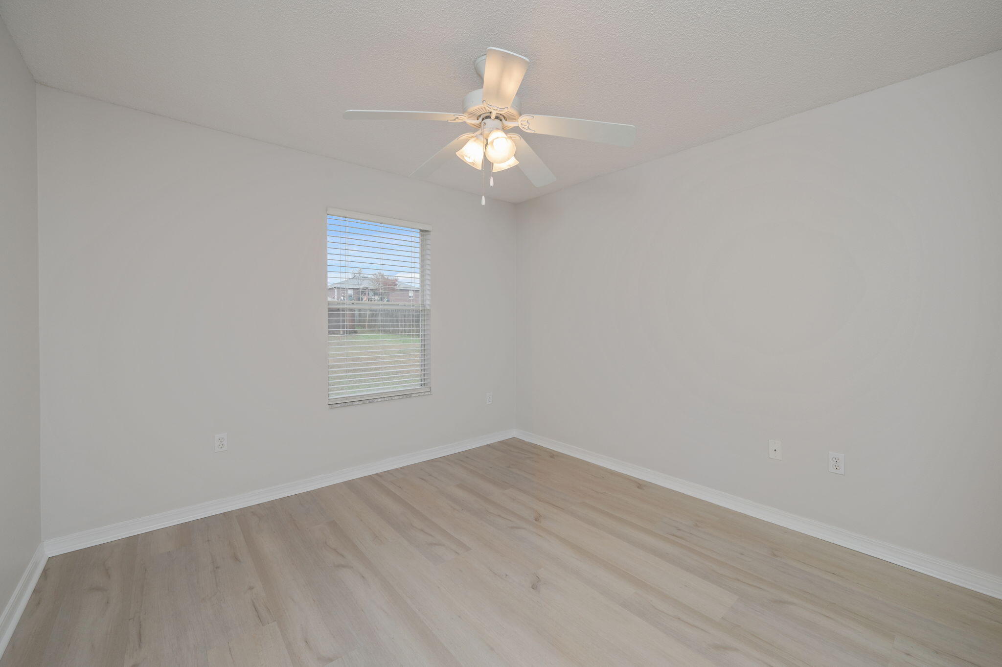 2405 Cumberland Way Crestview, FL 32536 - Photo 30 of 47 wooden floor in an empty room with a window