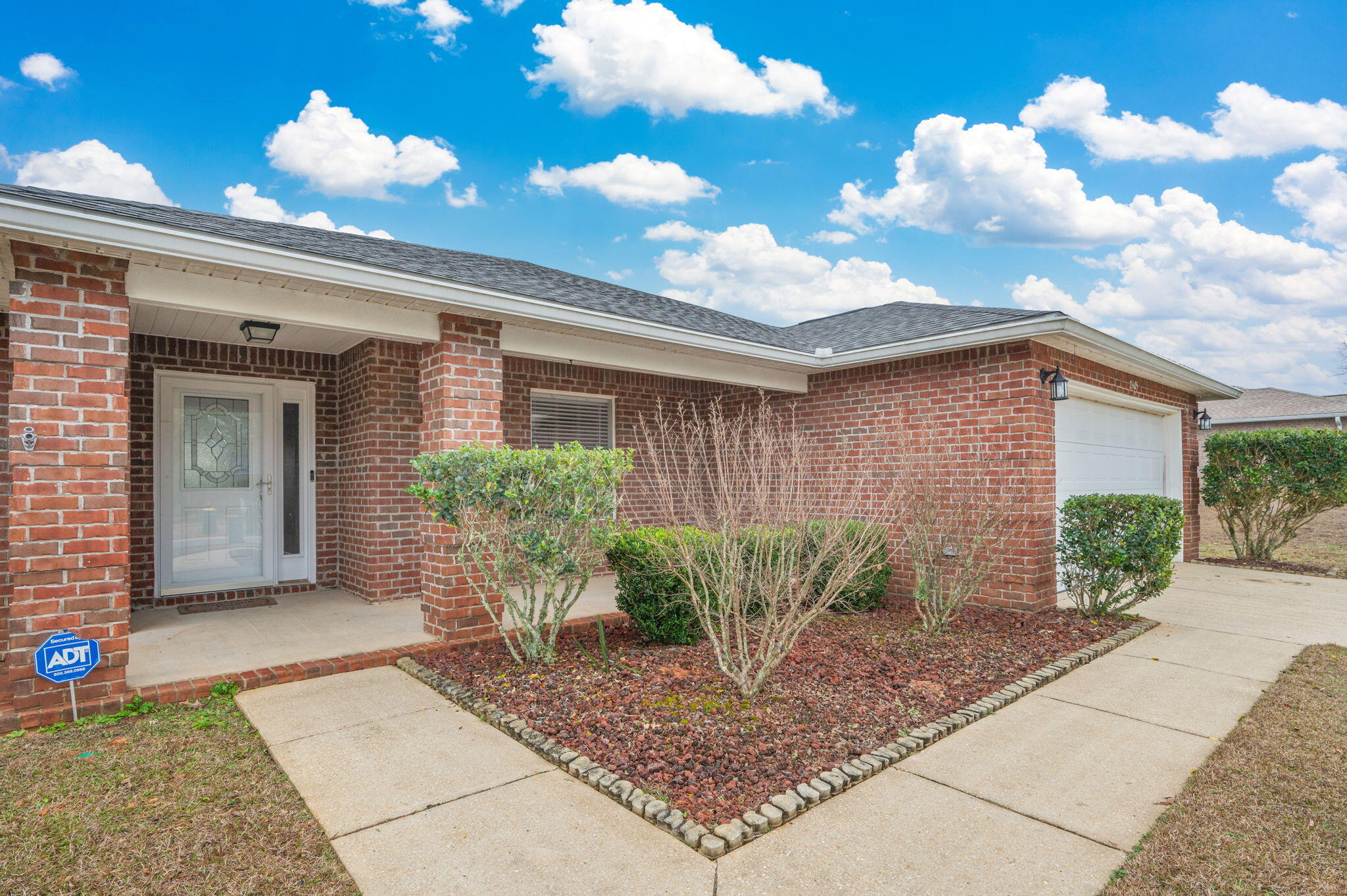 2405 Cumberland Way Crestview, FL 32536 - Photo 3 of 47 a front view of a house with garden