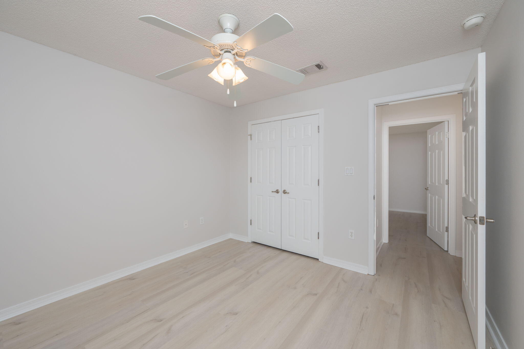 2405 Cumberland Way Crestview, FL 32536 - Photo 31 of 47 an empty room with wooden floor and fan