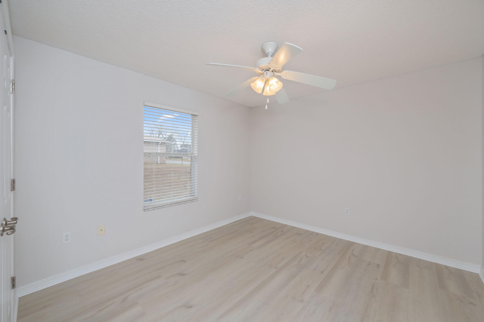 2405 Cumberland Way Crestview, FL 32536 - Photo 32 of 47 an empty room with a window and wooden floor