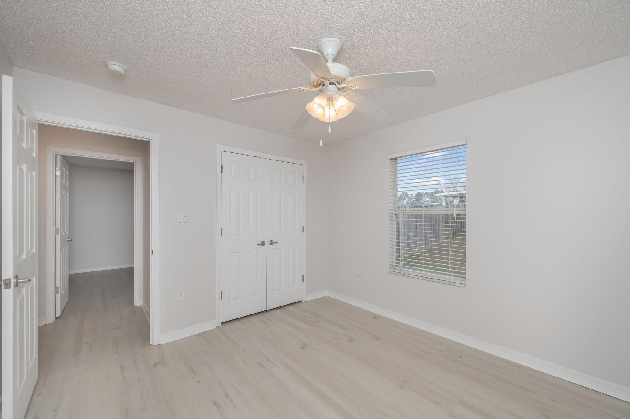 2405 Cumberland Way Crestview, FL 32536 - Photo 33 of 47 an empty room with wooden floor fan and windows