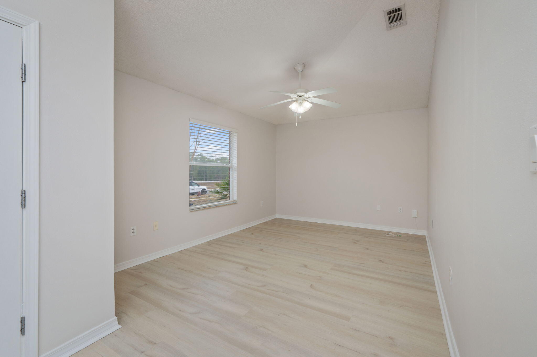 2405 Cumberland Way Crestview, FL 32536 - Photo 9 of 47 an empty room with a ceiling fan and window
