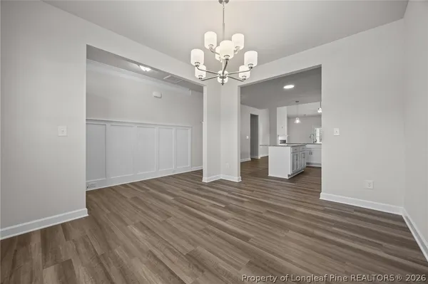 a large kitchen with stainless steel appliances granite countertop a large counter top a stove and a refrigerator