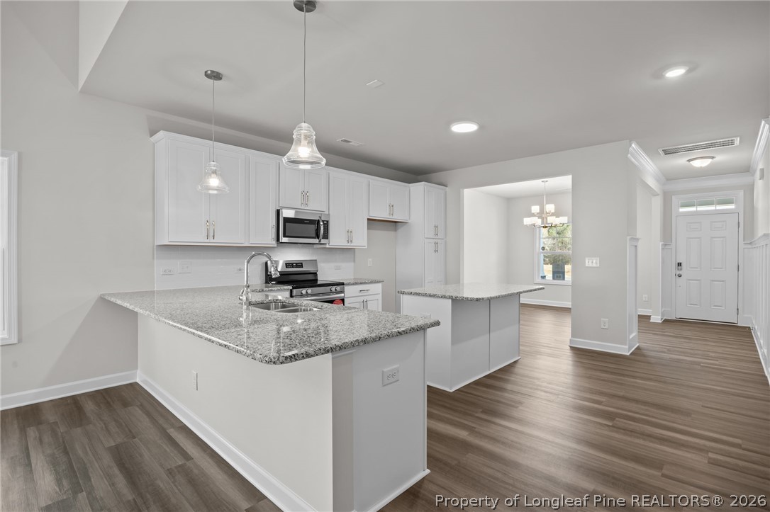 287 Elijah Way Vass, NC 28394 - Photo 19 of 49 a kitchen with a sink microwave and cabinets
