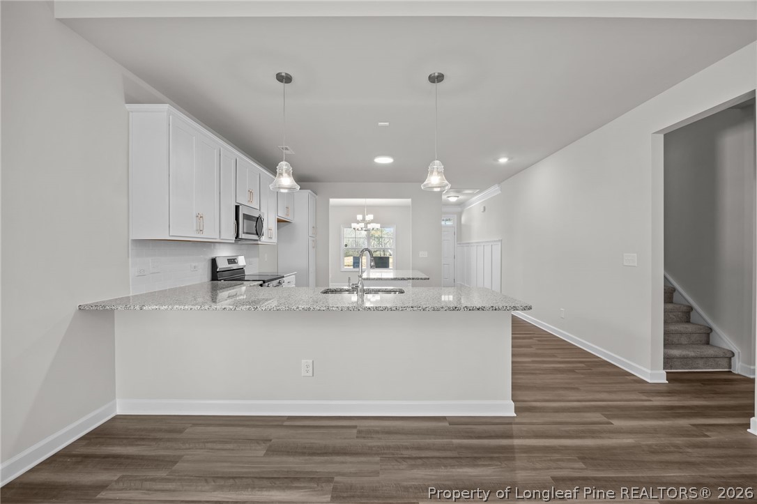 287 Elijah Way Vass, NC 28394 - Photo 20 of 49 a large kitchen with stainless steel appliances granite countertop a large counter top a stove and a refrigerator