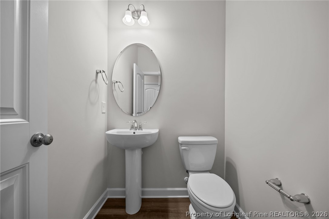 287 Elijah Way Vass, NC 28394 - Photo 25 of 49 a bathroom with a toilet a sink and a mirror