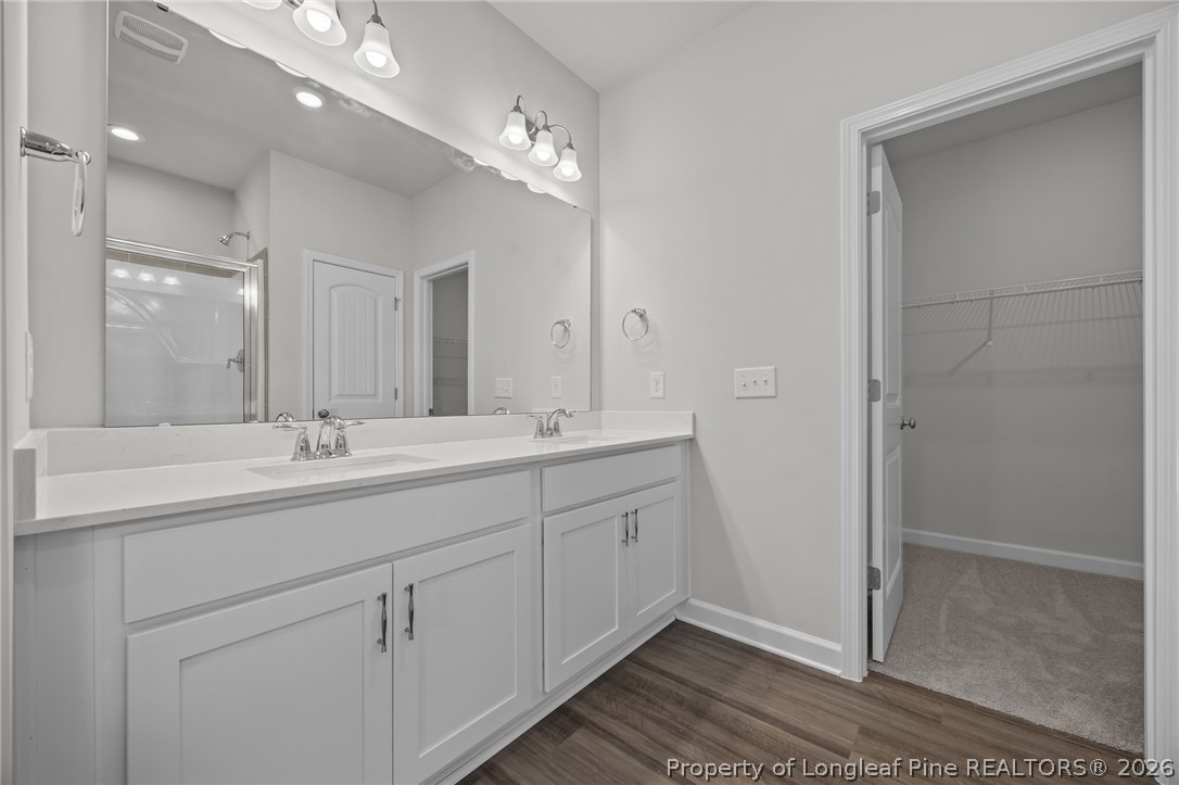 287 Elijah Way Vass, NC 28394 - Photo 30 of 49 a bathroom with 2 sink and a mirror
