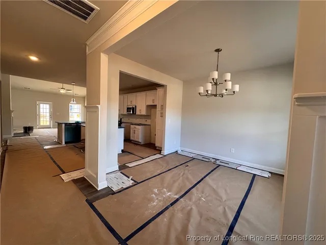 a view of kitchen with furniture and chandelier