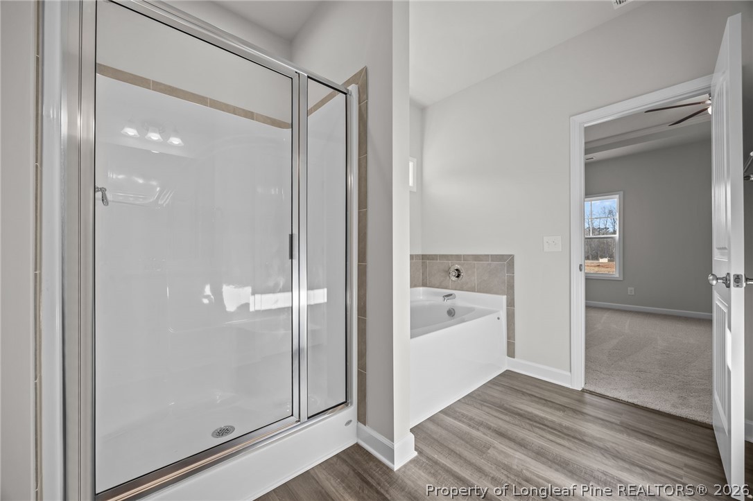 287 Elijah Way Vass, NC 28394 - Photo 31 of 49 a bathroom with a bathtub and a shower
