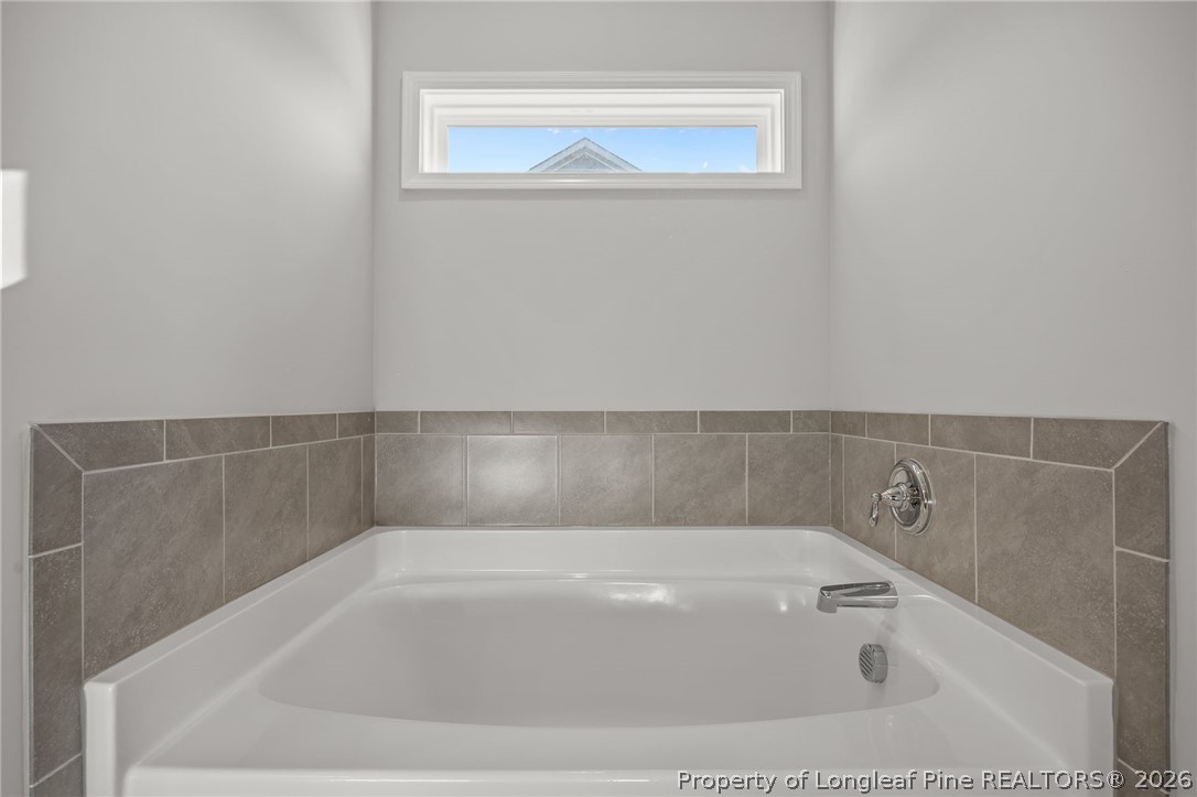 287 Elijah Way Vass, NC 28394 - Photo 32 of 49 a bath tub sitting next to a white sink