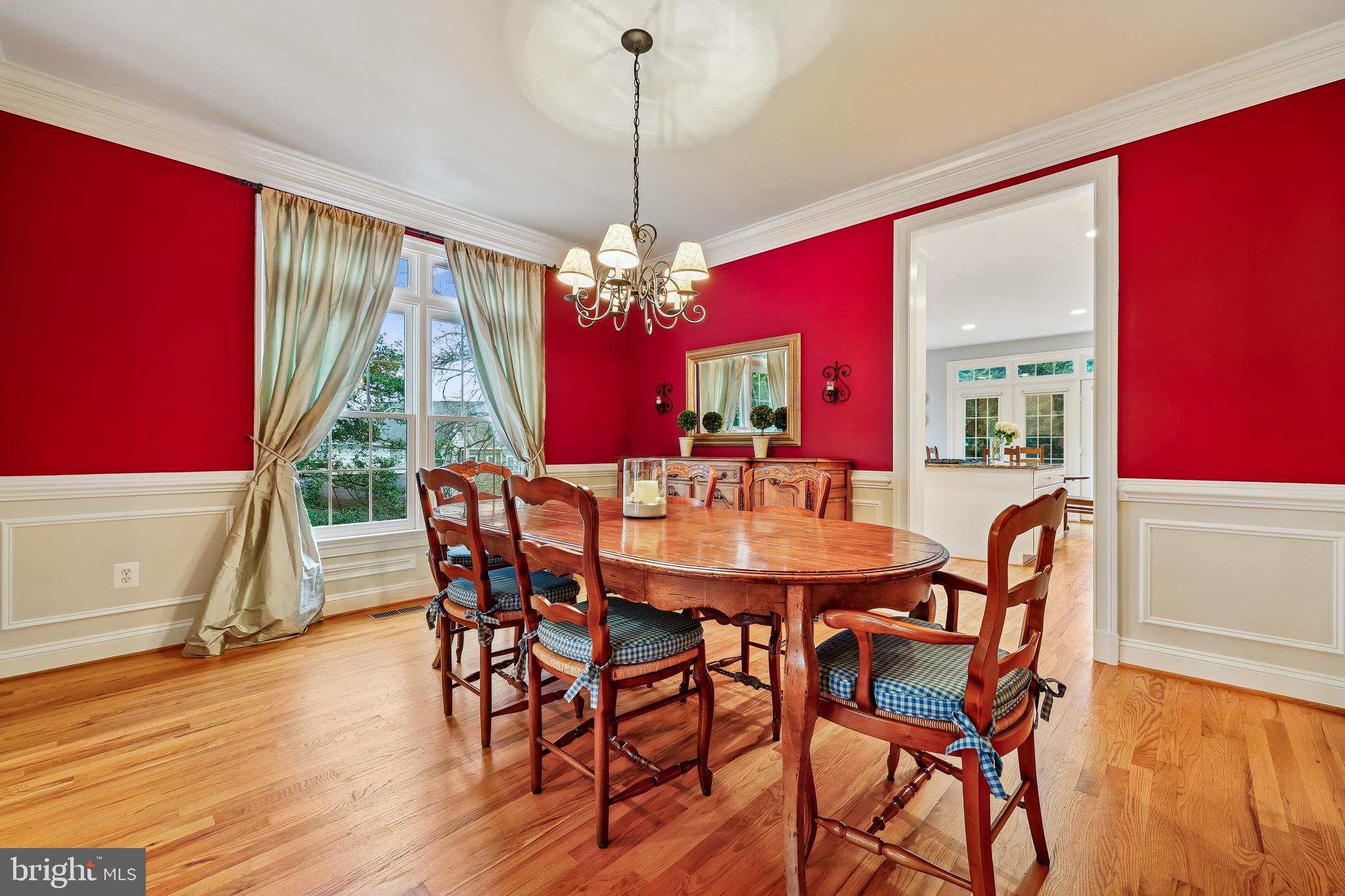 8807 Ridge Road Bethesda, MD 20817 - Photo 14 of 72 a dining room with furniture a chandelier and wooden floor