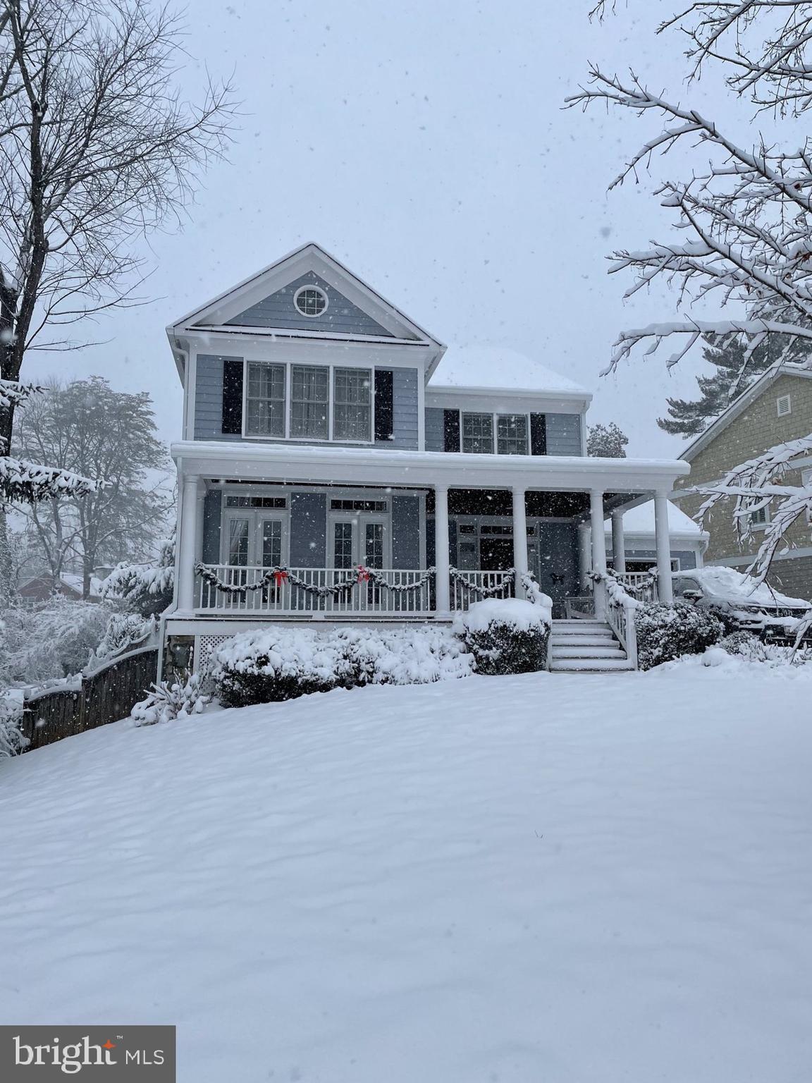 8807 Ridge Road Bethesda, MD 20817 - Photo 2 of 72 a front view of a house with a yard covered in snow