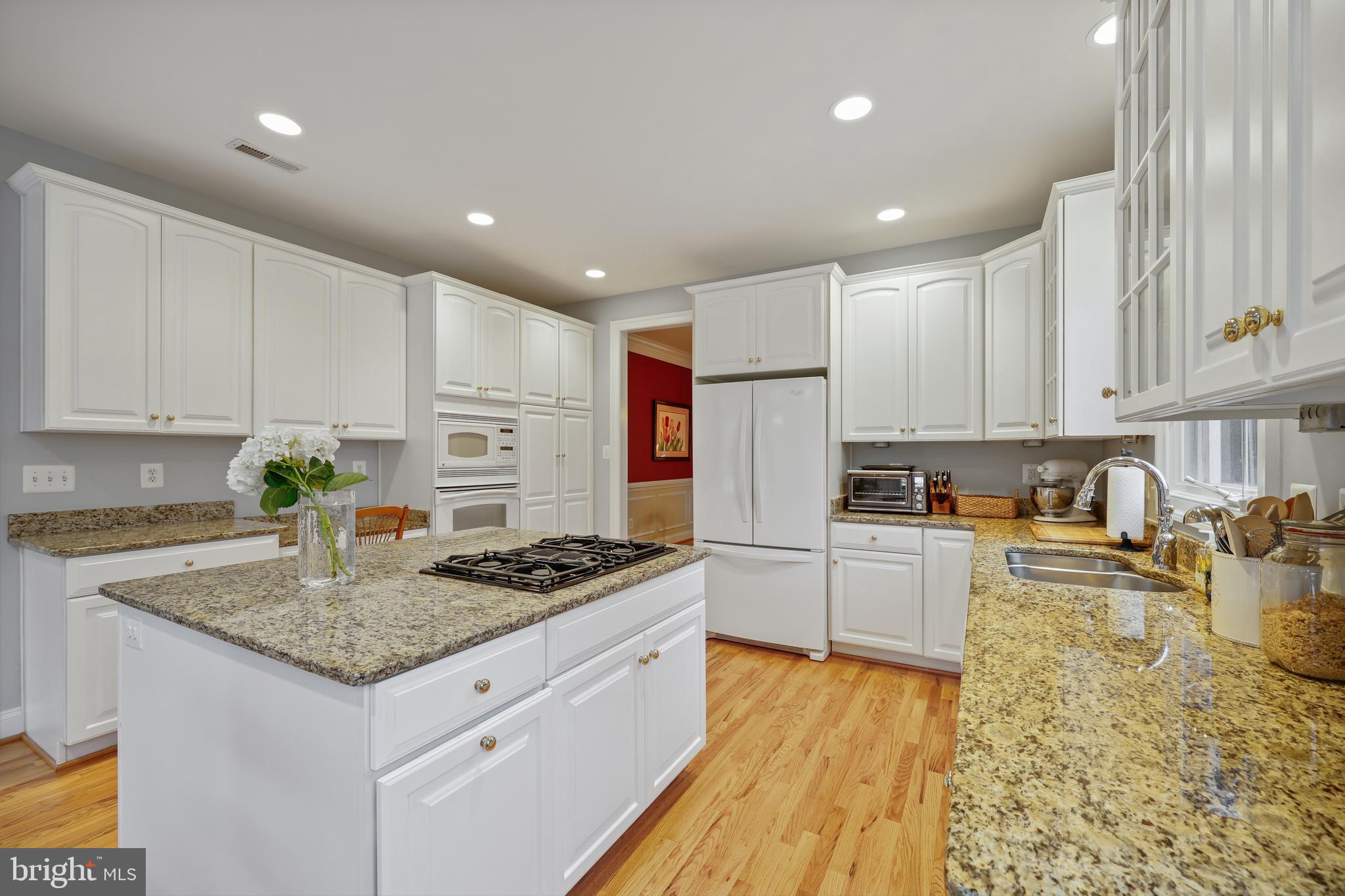 8807 Ridge Road Bethesda, MD 20817 - Photo 21 of 72 a kitchen with stainless steel appliances granite countertop a sink stove and refrigerator
